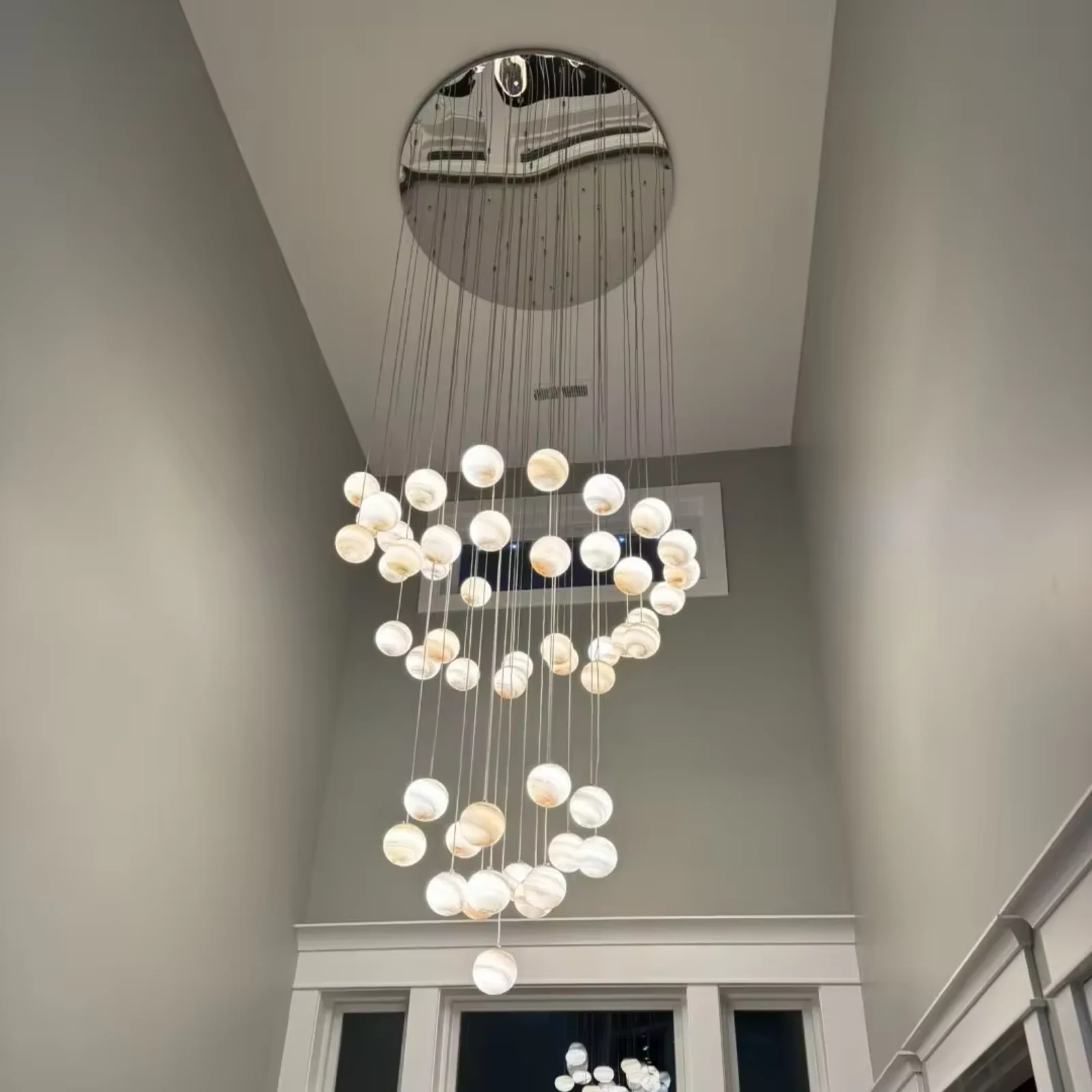 Custom-designed multi-hanging spherical chandeliers, suitable for double-height foyer