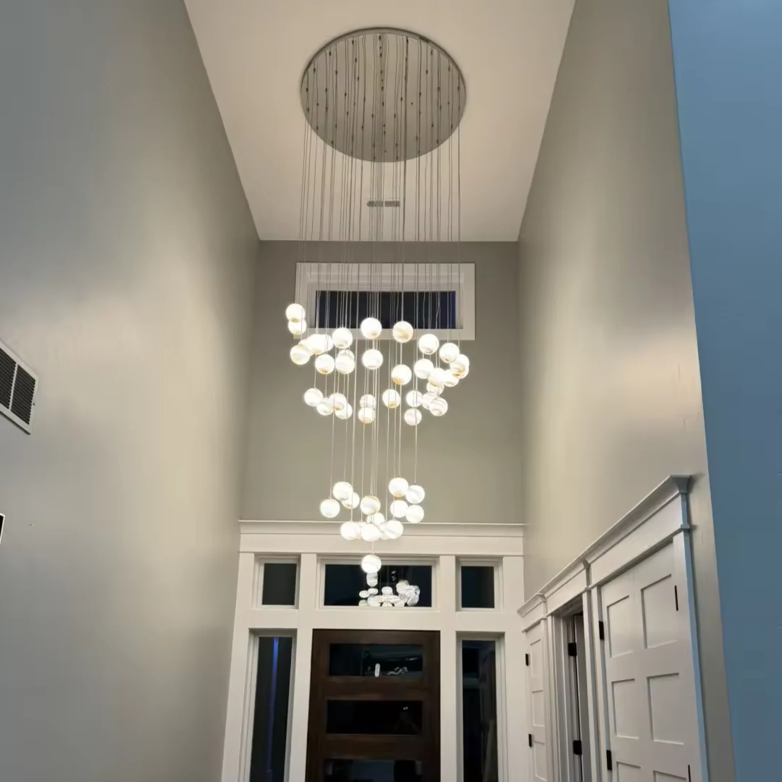 Custom-designed multi-hanging spherical chandeliers, suitable for double-height foyer project view