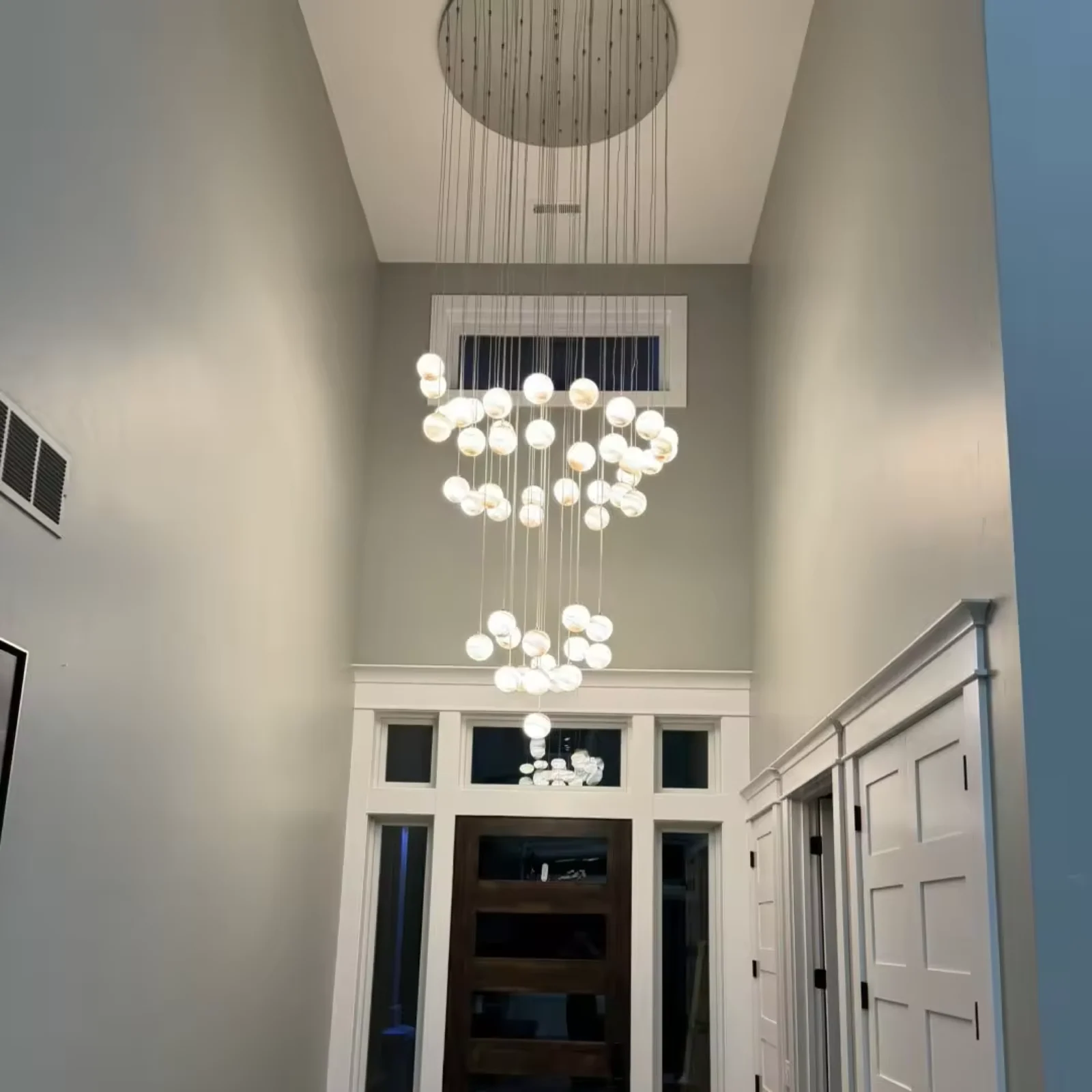 Custom-designed multi-hanging spherical chandeliers, suitable for double-height foyer project view