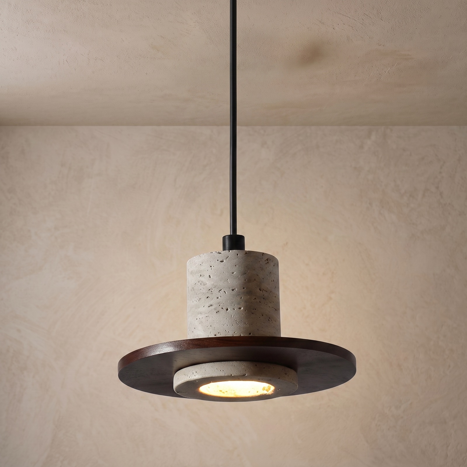 Travertine pendant light with a warm porous stone texture and dark wood detail.